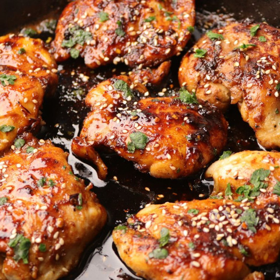 Glazed honey garlic chicken on a cast iron skillet