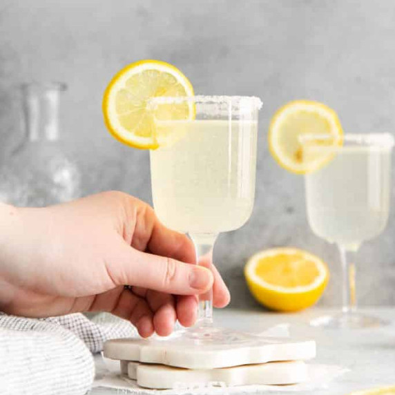 Glasses of vodka sidecar cocktail garnished with lemon slice and sugar on the rim 