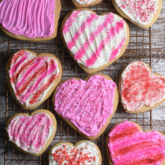 Pink frosted heart shape cookies with sprinkles