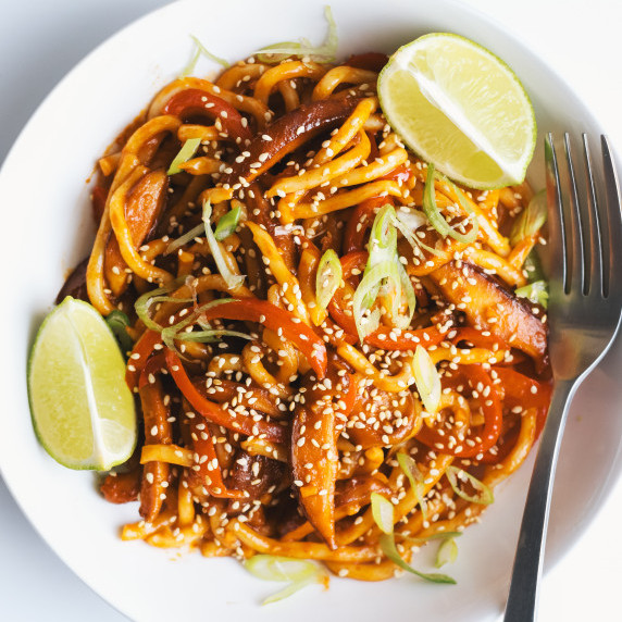 Gochujang noodles in a bowl with lime wedges