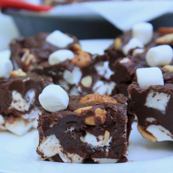 Rocky Road Fudge on a white plate with a red spatula.  