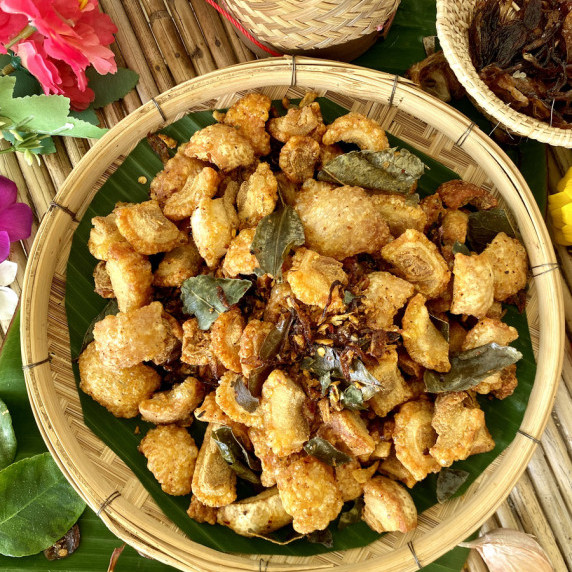 Top view of hot and spicy pork rinds with Thai herbs and spices.