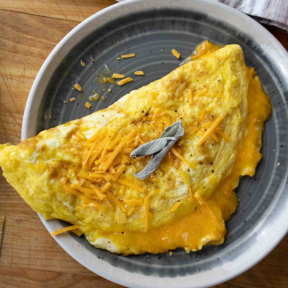 sage and cheddar omelette on a plate
