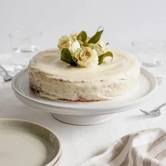 lemon olive oil cake on a white cake stand
