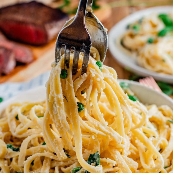 Fettuccine and steak being served.