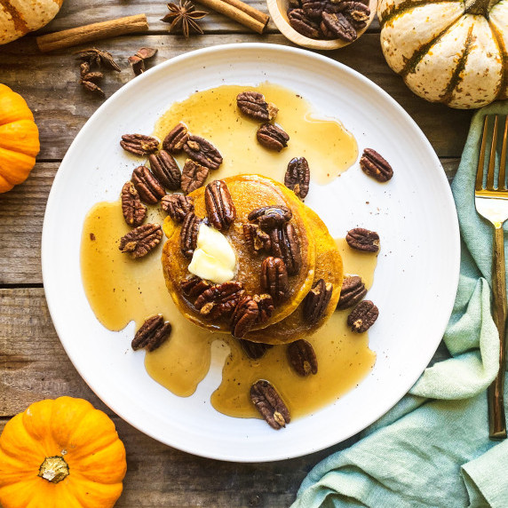 Pumpkin spice pancakes with roasted pecans, butter and maple syrup