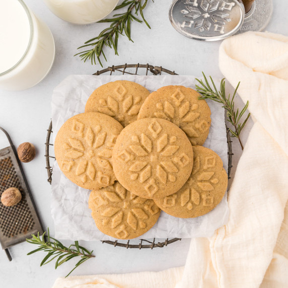 stamped nutmeg cookies on a cooling rack with a white napkin