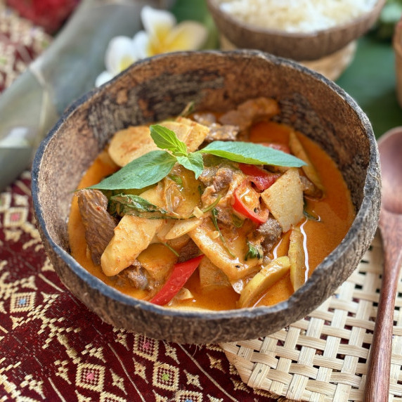 Thai bamboo shoot curry served in a coconut shell.