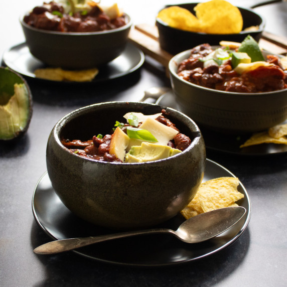 bowls of turkey chili with cheese and sour cream topping