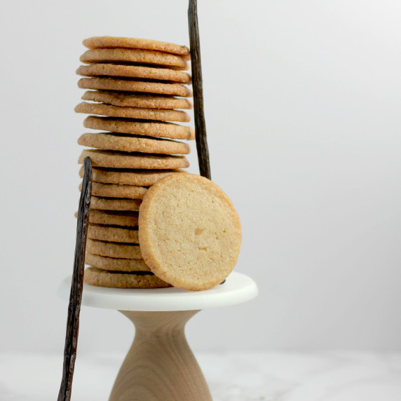 A stack of double vanilla bean short bread cookies with Madagascar vanilla beans on the sides