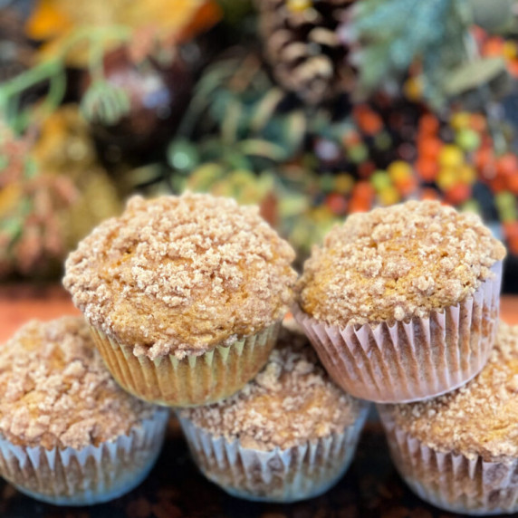 cinnamon streusel pumpkin muffins on a wood board