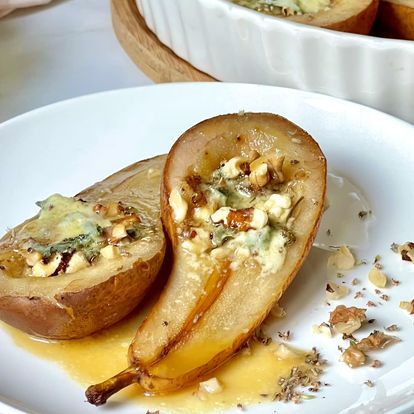 Baked Gorgonzola Pears on a plate, drizzled with honey and finished off with chopped walnuts 