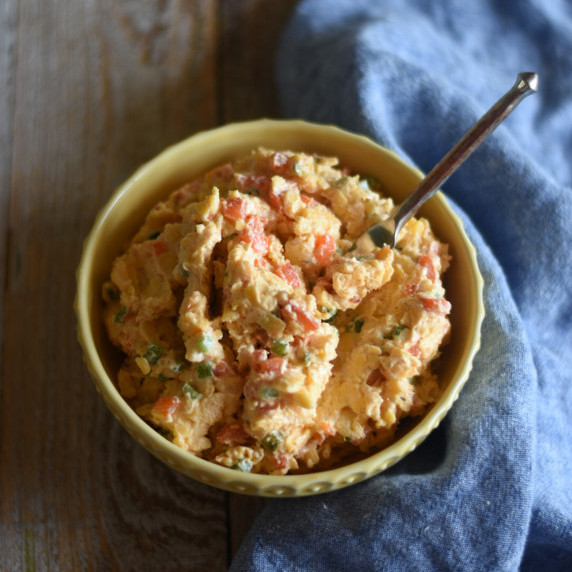Spicy Pimento Cheese in a yellow bowl with a blue napkin