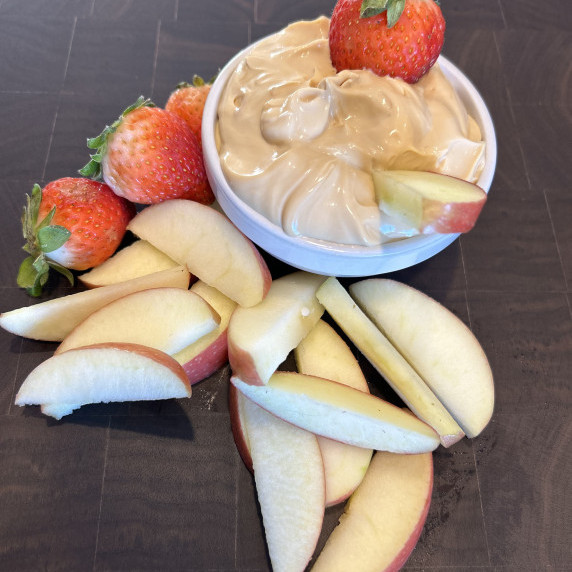 2 ingredient fruit dip surrounded by strawberries and apple slices.