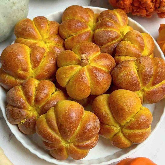 Pumpkin-Shaped Bread Rolls On a ceramic plate