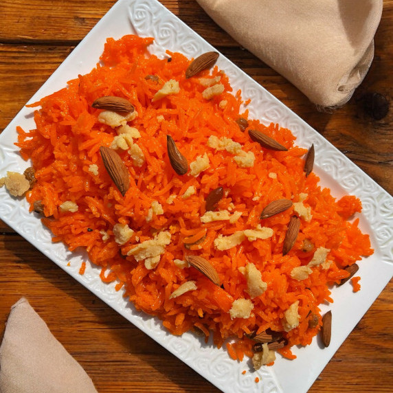 Zarda rice arranged in white dish on a jute mat