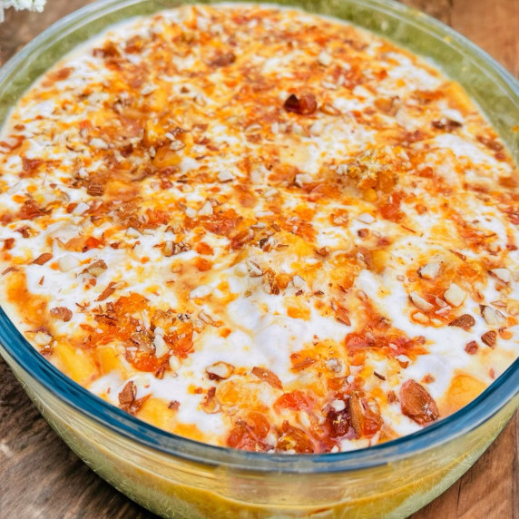 Caramel crunch trifle arranged in glass dish placed on green cloth 