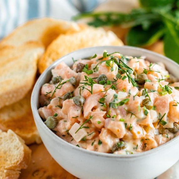 Salmon tartare in bowl, with bread.