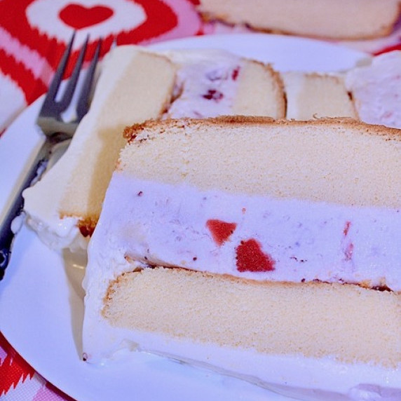 Loaf Pan Strawberry Ice Cream Cake on a white plate on a Valentine's Day tablecloth.  