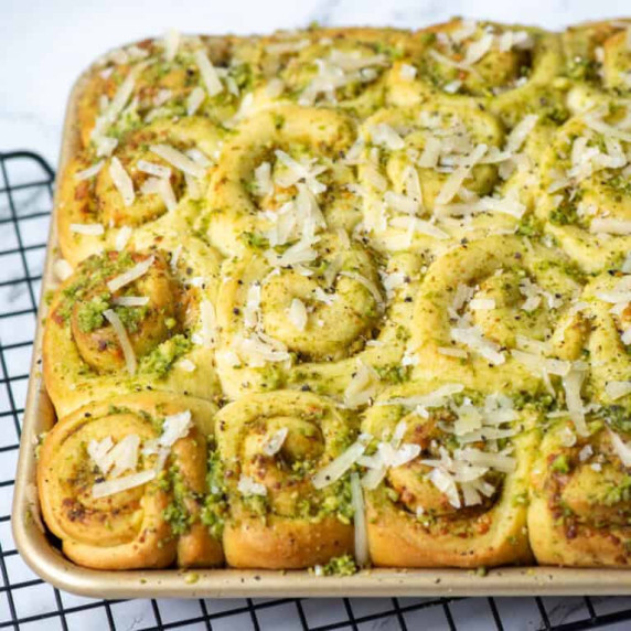 Overhead photo of mini pinwheel pesto rolls in a baking pan 