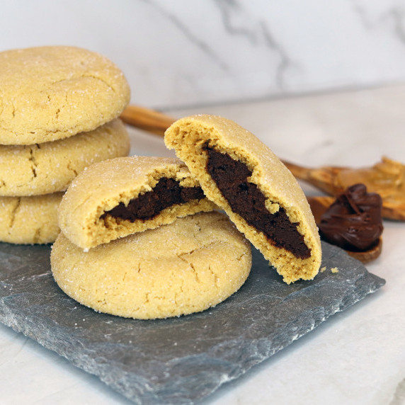 Inside Out Magic in the Middle Cookies stacked on a slate serving board against a marble background