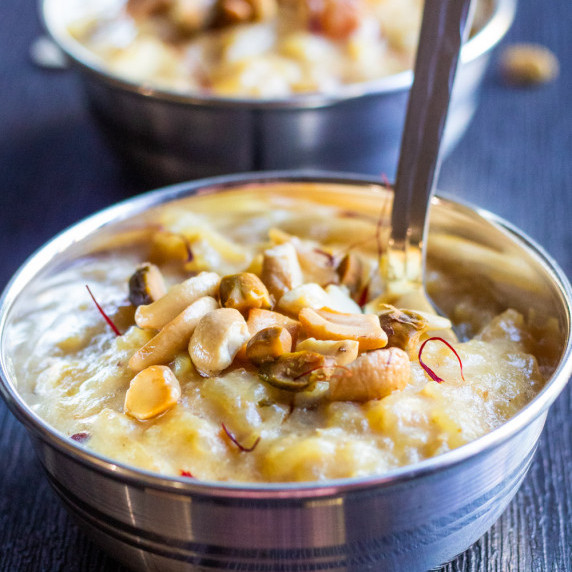Instant pot rice pudding in silver color bowls with nuts garnished on top
