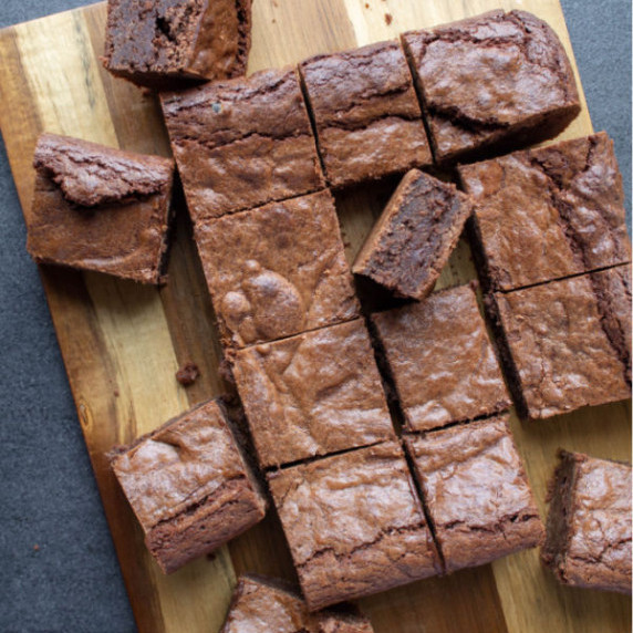 cut pieces of kahlua brownies scattered on a wooden board