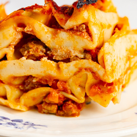 Homemade lasagna with layers of fresh pasta, rich Bolognese sauce, creamy béchamel, and golden melte