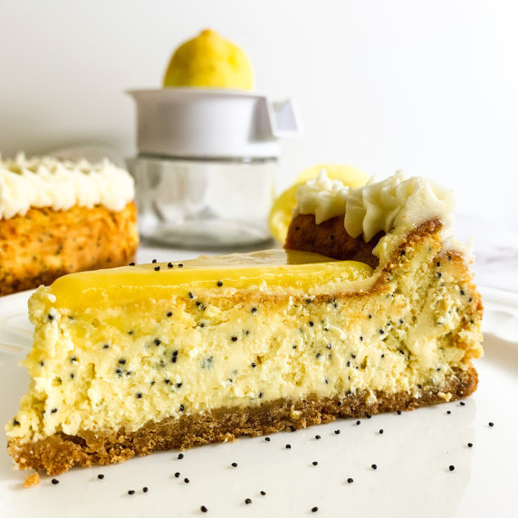 Slice of lemon poppyseed cheesecake on a white plate