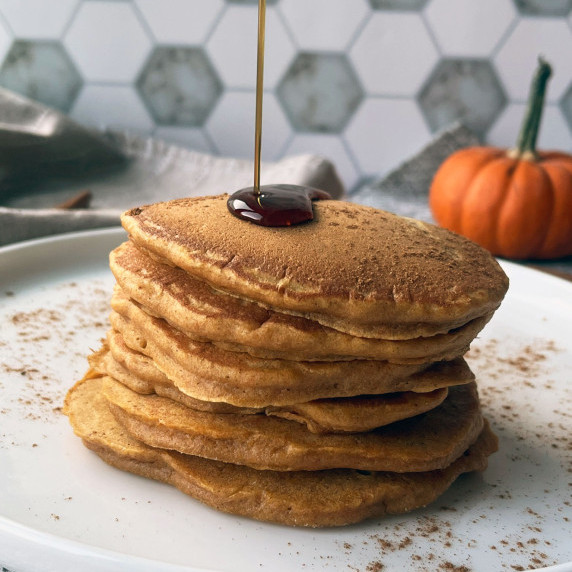 pumpkin pancakes with syrup drizzle