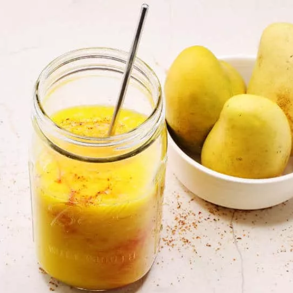 Mangonada as a Mexican mango smoothie prepared with fresh-cut mango and spiced up with chamoy chili 