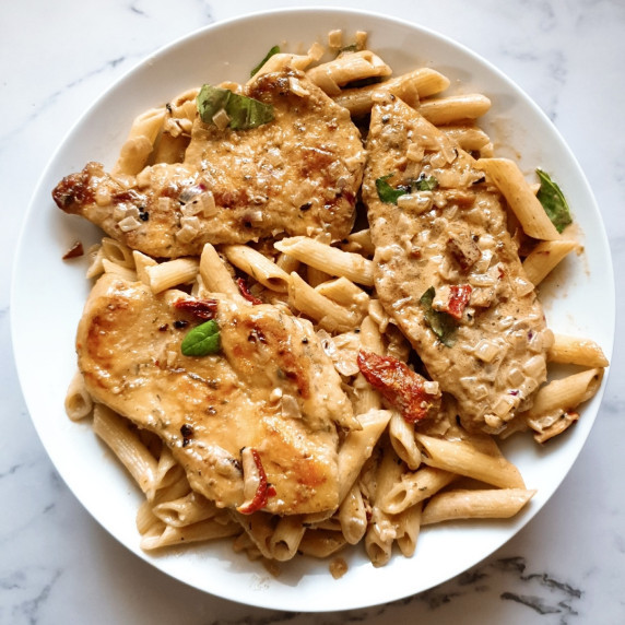 Marry Me Chicken Recipe with Pasta served on a white plate.