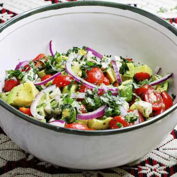 Mexican style avocado salad recipe in white bowl