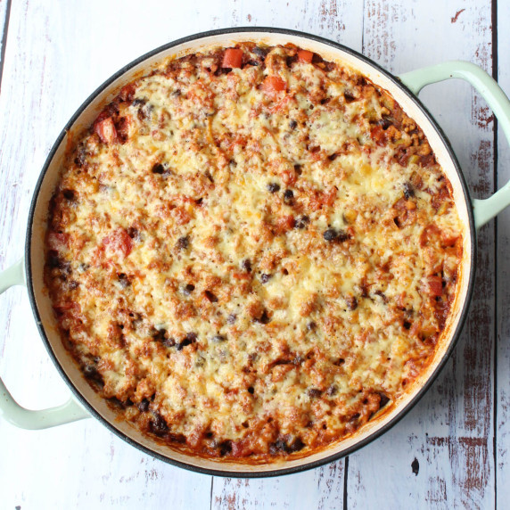  Mexican chicken and rice in a dutch oven, with golden cheesy top.