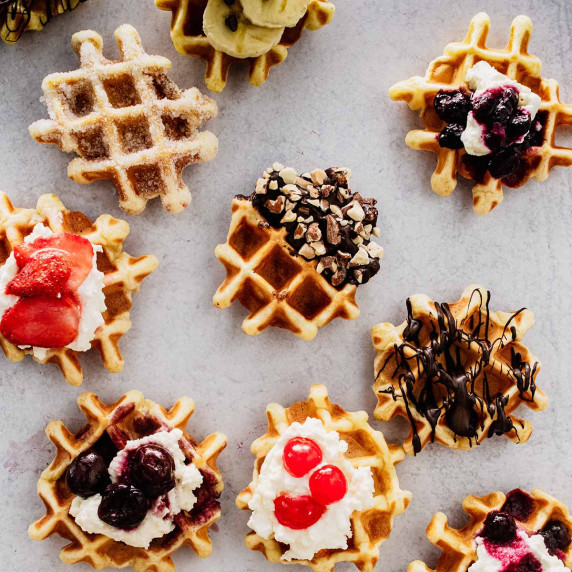 Overhead view of mini waffles with various toppings