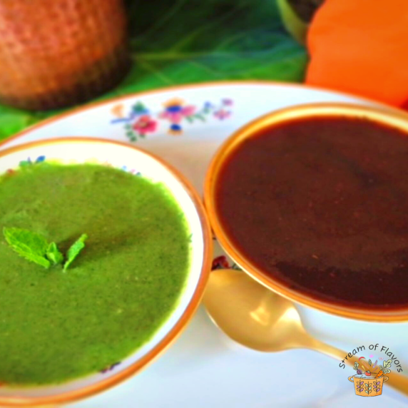 Mint and tamarind chutneys is two bowls on a plate