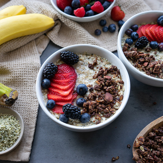 Oatmeal in a bowl with mixed fresh berries and chocolate granola