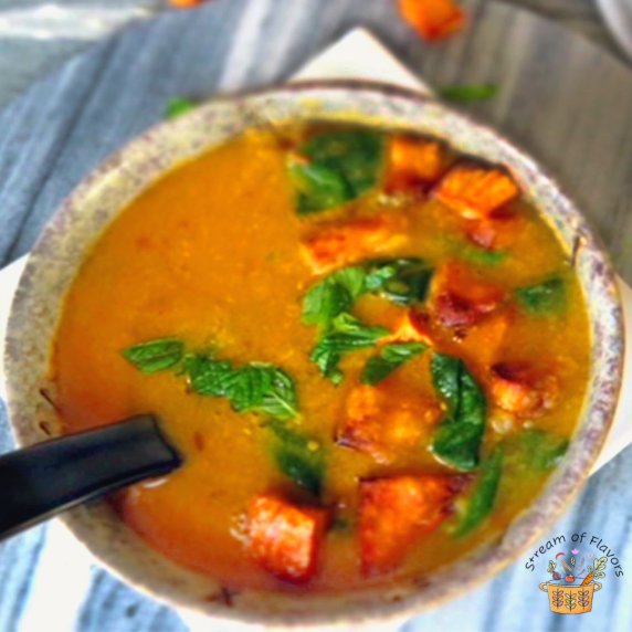 Moroccan Red Lentil Soup with spinach and sweet potato in a gray bowl