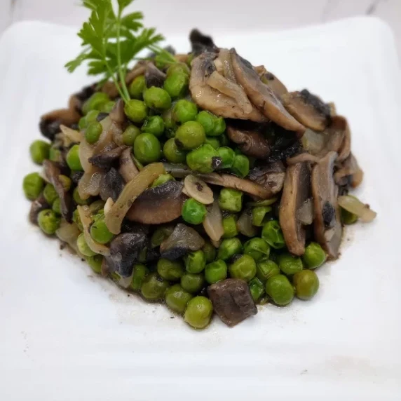 Mushrooms and Peas Recipe. Sliced mushrooms sauteed in olive oil with garlic and sweet peas.