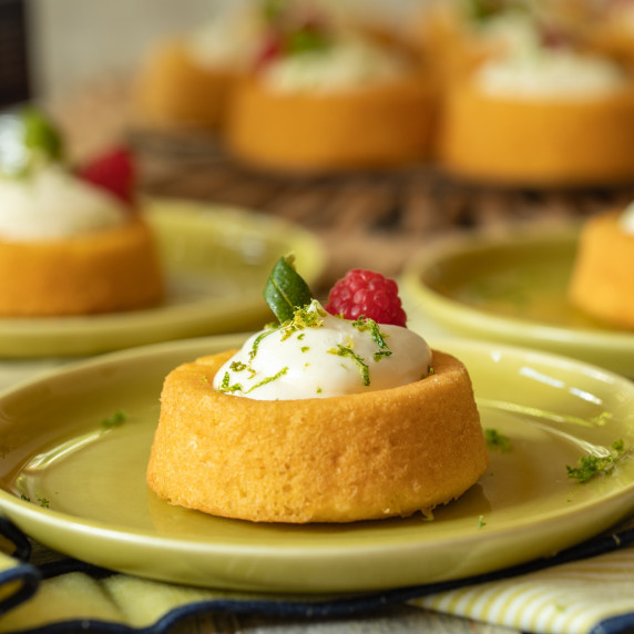A mini margarita cheesecake dessert on a lime green plate.