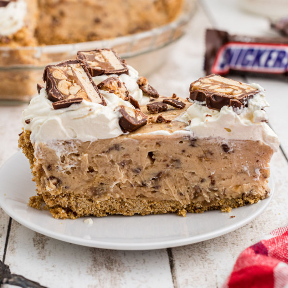 Close up of a slice of no bake snickers pie.