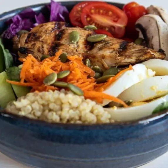 Nourish Bowl with chicken, eggs, fruit and vegetables