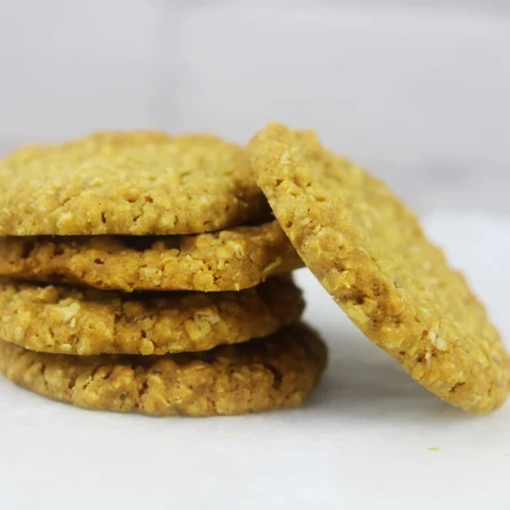 A stack of oat biscuits sitting on a grey background