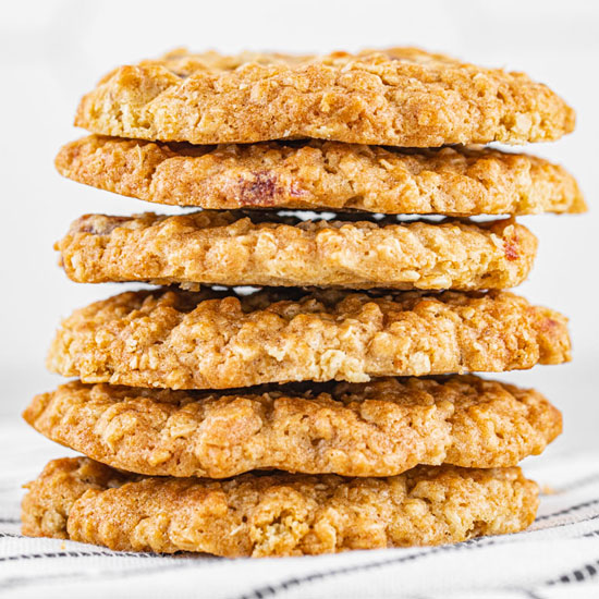 Six Baked Oatmeal Guava Cookies arranged one in top of the other over a thin black stripe and white 