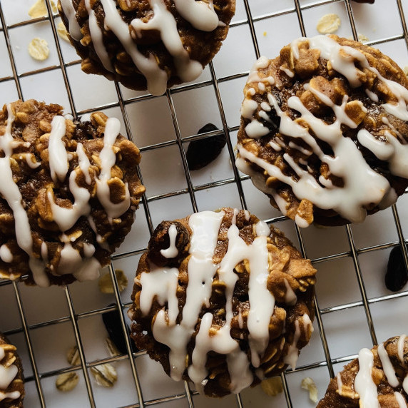 Baked oatmeal bites on a cooling rack drizzled with a white glaze. 