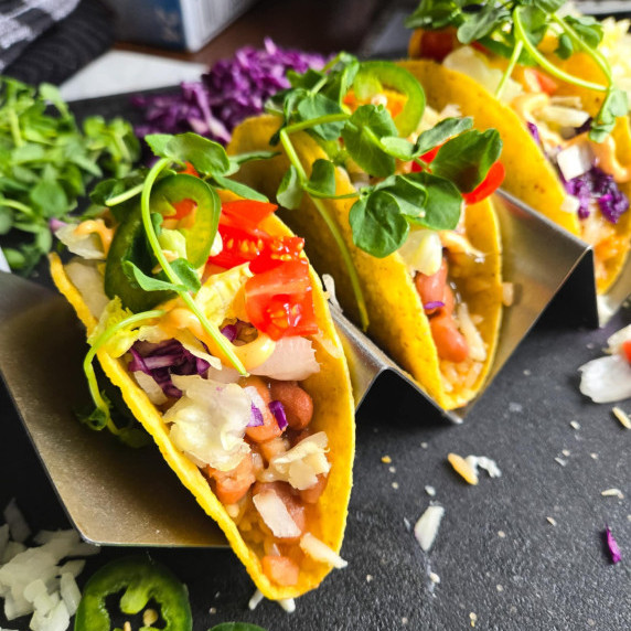Hard shell tacos stuffed with colourful garnishes 