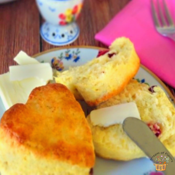 Orange scones with milk, butter, eggs, flour, orange zest and cranberries with butter and jam