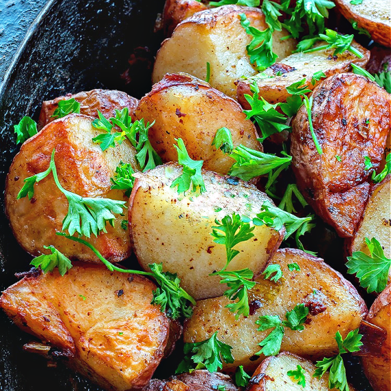 Oven roasted parsley potatoes in a cast iron pan