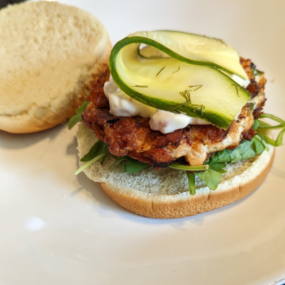 Salmon Burger with pickle on top
