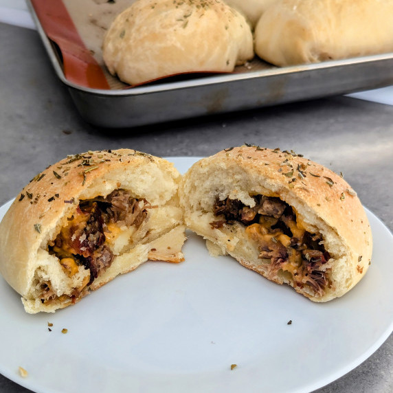 A Brisket and Cheddar pocket cut open to show the inside of brisket and cheddar.